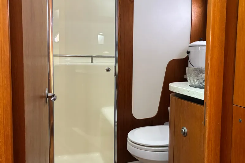 Slide: The Image of 2007 Tiara 3900 Sovran yacht bathroom with wooden cabinetry and modern fixtures. - 55