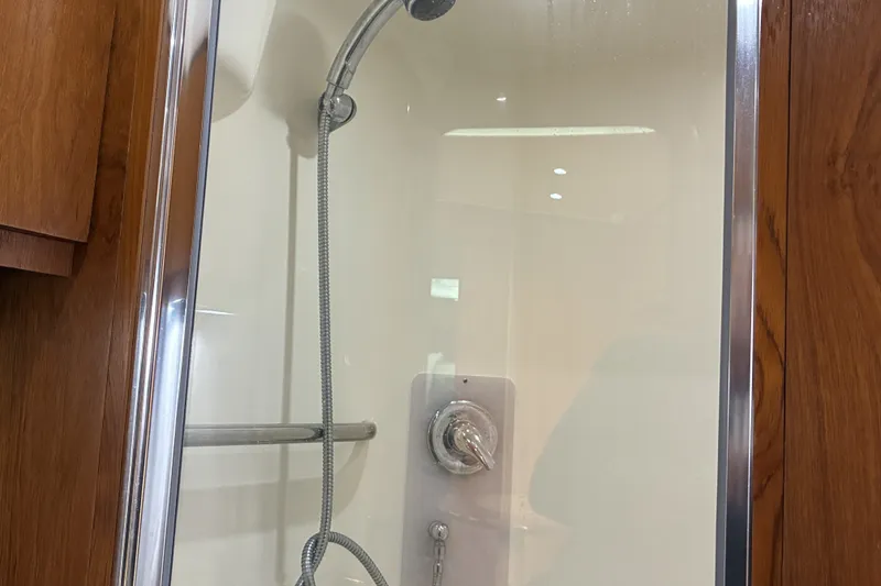 Slide: The Image of Shower area inside 2007 Tiara 3900 Sovran yacht, featuring chrome fixtures and wooden accents. - 57