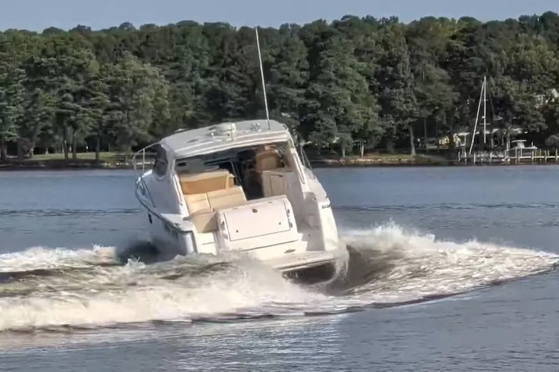 Slide: The Image of 2007 Tiara 3900 Sovran yacht making a sharp turn on a calm lake. - 7