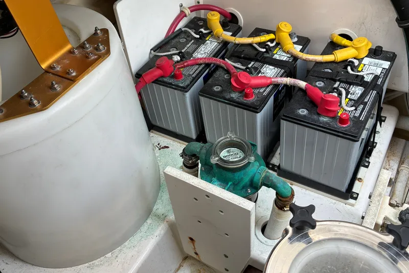 Slide: The Image of Battery compartment of a 2007 Tiara 3900 Sovran boat with connected cables. - 66