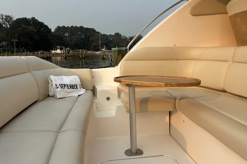 Slide: The Image of Luxurious seating area on a 2007 Tiara 3900 Sovran yacht with a wooden table. - 22