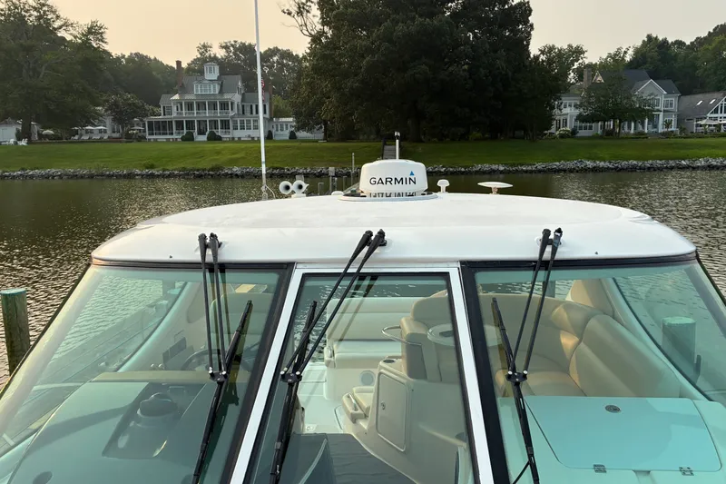 Slide: The Image of 2007 Tiara 3900 Sovran yacht with Garmin equipment, docked near waterfront homes. - 17