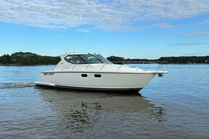 Slide: The Image of 2007 Tiara 3900 Sovran yacht cruising on a calm lake under a blue sky. - 1