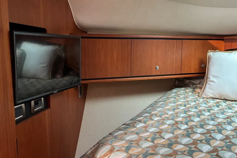Slide: The Image of Luxurious cabin interior of 2007 Tiara 3900 Sovran yacht with TV and bedding. - 52