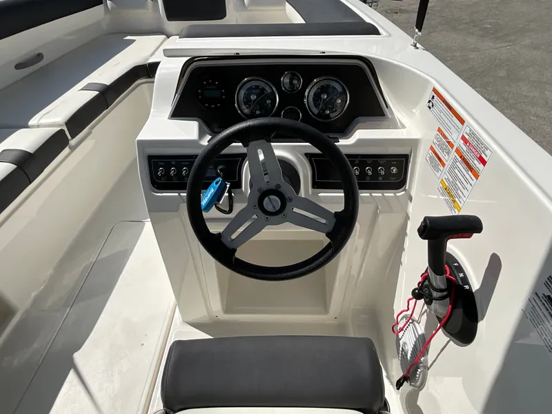 Slide: The Image of The image shows the helm of a 2021 Bayliner DX 2050 with modern instruments. - 12