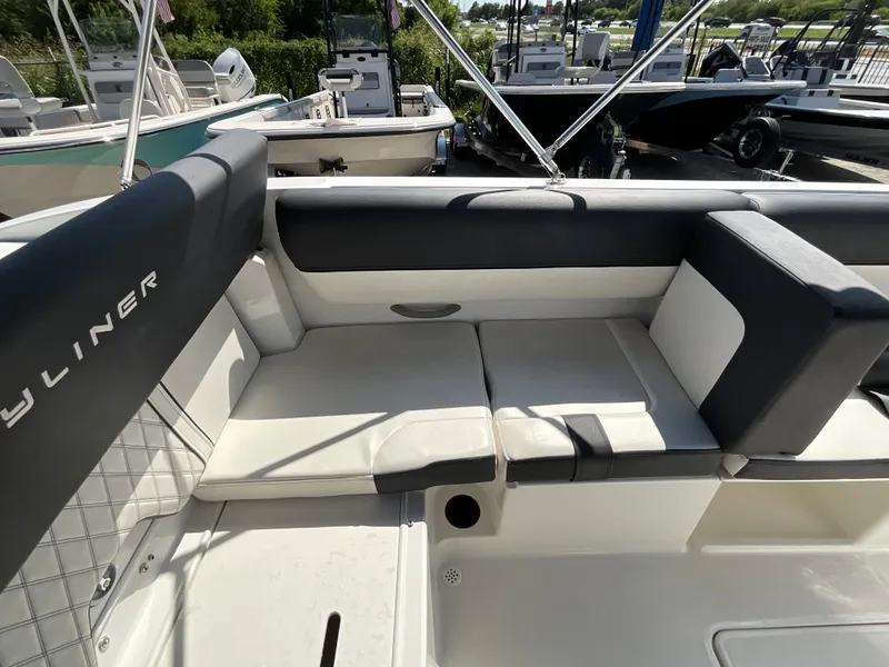 Slide: The Image of The image shows the cockpit of a 2021 Bayliner DX 2050 with cushioned seating. - 9