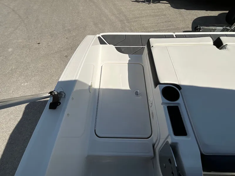Slide: The Image of The image shows the deck of a 2021 Bayliner DX 2050 with storage and cup holders. - 6