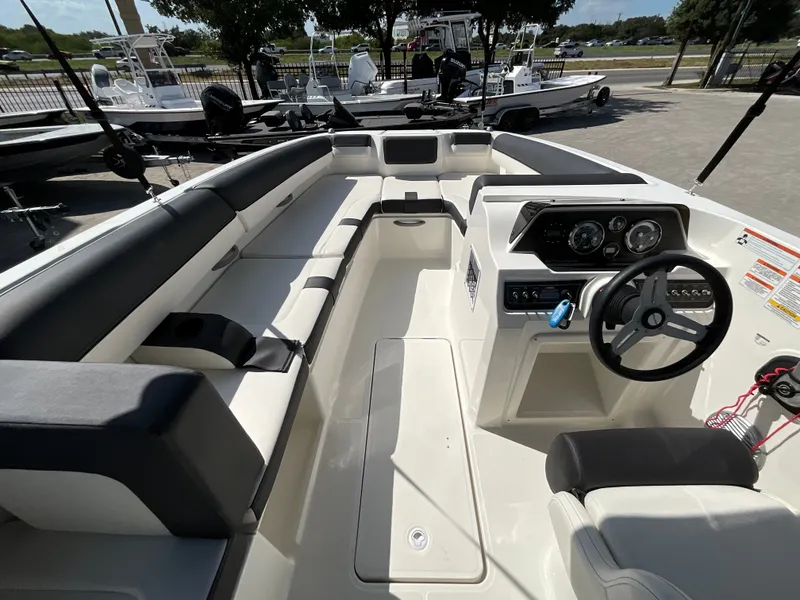 Slide: The Image of The image shows the cockpit of a 2021 Bayliner DX 2050 with modern instruments and comfortable seating. - 13