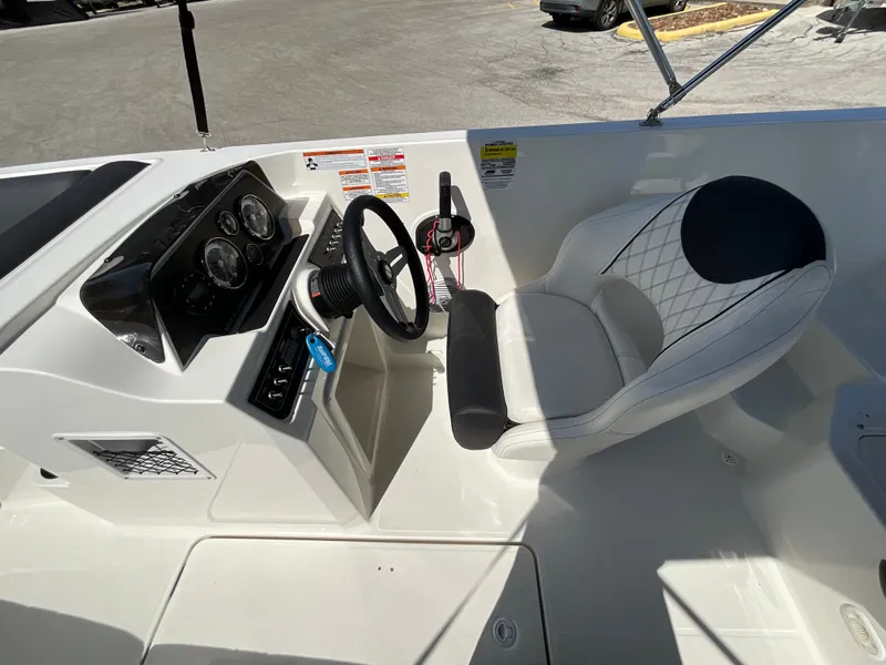 Slide: The Image of The image shows the cockpit of a 2021 Bayliner DX 2050 with a sleek helm and cushioned seat. - 11