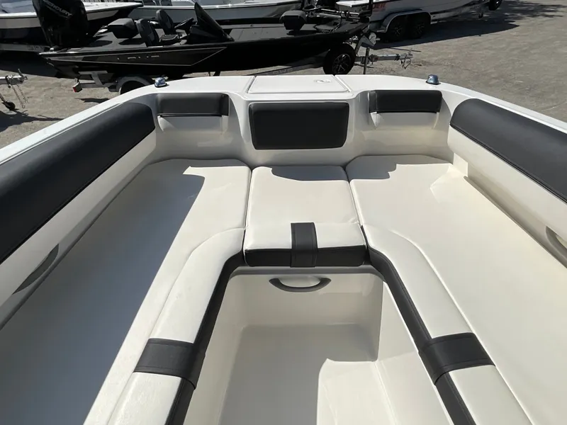 Slide: The Image of The image shows the bow area of a 2021 Bayliner DX 2050 with cushioned seating. - 14