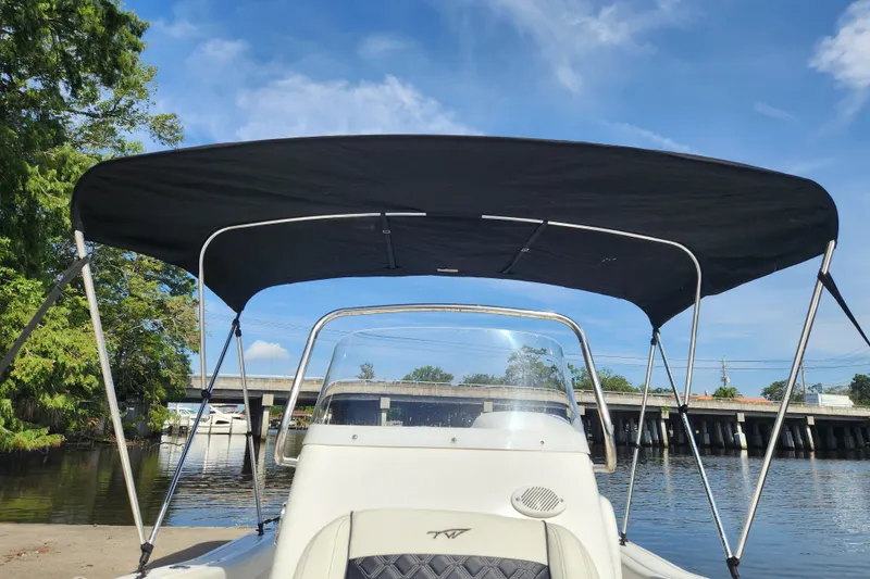 Slide: The Image of 2023 Tidewater 196 CC Adventure boat with canopy on a sunny day by the water. - 28