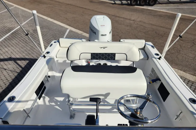 Slide: The Image of 2023 Tidewater 196 CC Adventure boat interior with steering wheel and seating. - 41