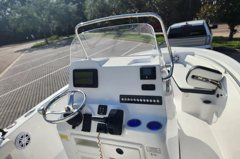 Slide: The Image of 2023 Tidewater 196 CC Adventure boat dashboard with steering wheel and controls. - 37