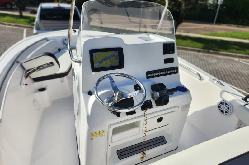 Slide: The Image of 2023 Tidewater 196 CC Adventure boat console with steering wheel and navigation display. - 36