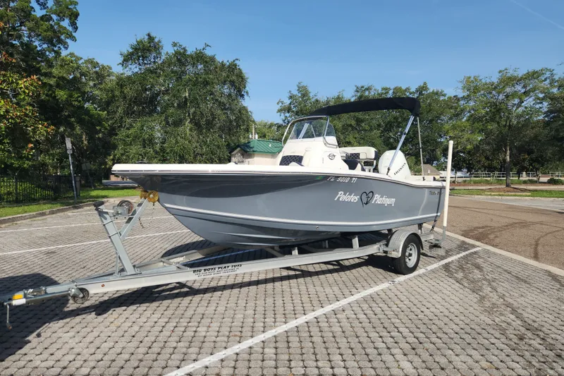 Slide: The Image of 2023 Tidewater 196 CC Adventure boat on trailer in sunny parking lot. - 5