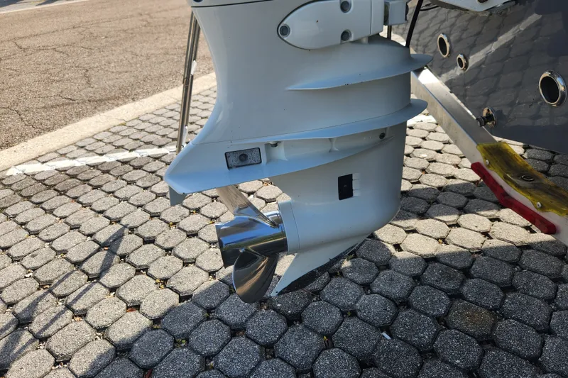 Slide: The Image of 2023 Tidewater 196 CC Adventure boat motor and propeller on paved surface. - 22