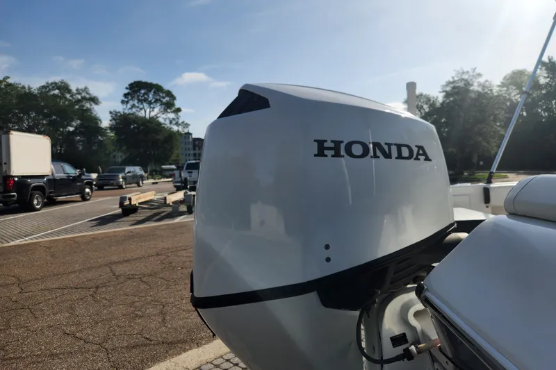 Slide: The Image of 2023 Tidewater 196 CC Adventure with Honda outboard motor in parking lot. - 21