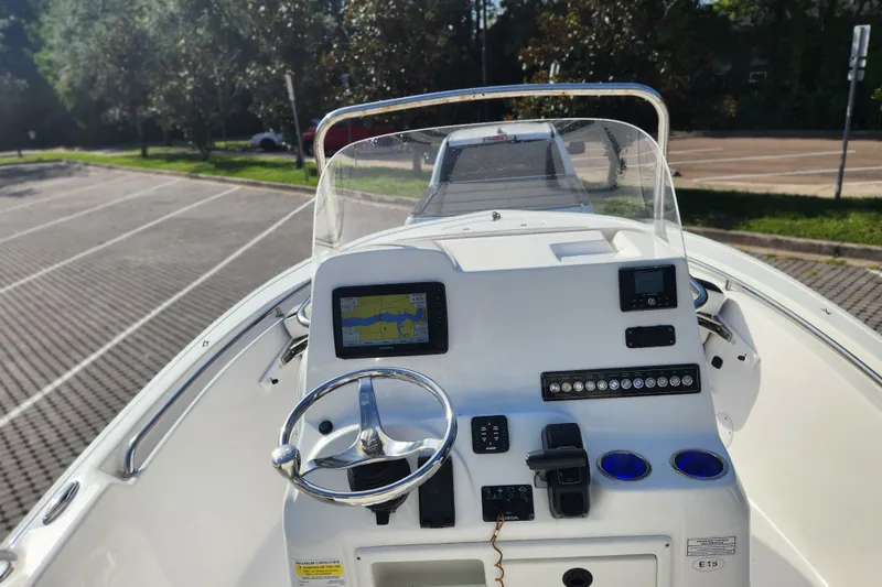 Slide: The Image of 2023 Tidewater 196 CC Adventure boat dashboard with navigation system and steering wheel. - 38