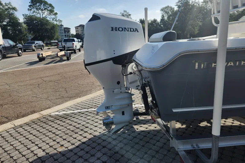 Slide: The Image of 2023 Tidewater 196 CC Adventure boat with Honda outboard motor on a trailer. - 14