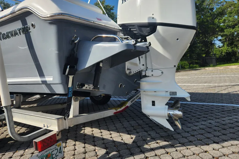 Slide: The Image of 2023 Tidewater 196 CC Adventure boat on trailer, showcasing outboard motor and hull details. - 17