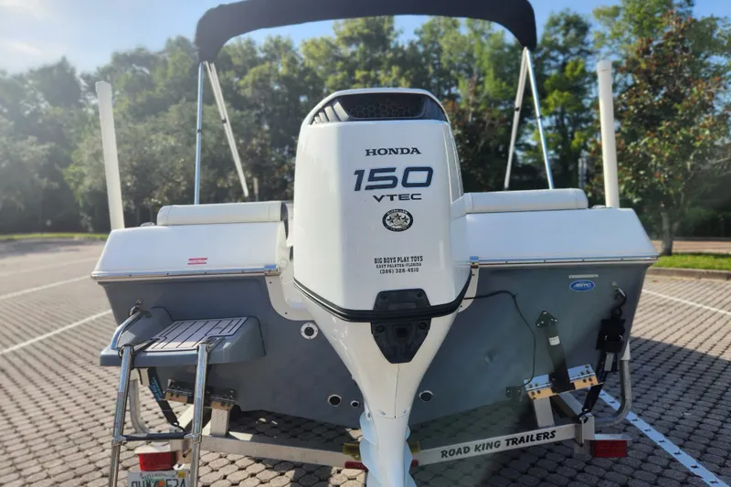 Slide: The Image of 2023 Tidewater 196 CC Adventure boat with Honda 150 VTEC engine, parked on trailer. - 12