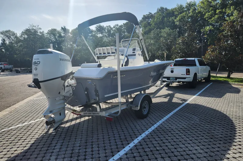 Slide: The Image of 2023 Tidewater 196 CC Adventure boat on trailer, Honda 150 VTEC engine, parked near white truck. - 8
