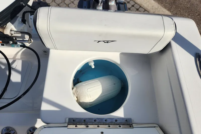 Slide: The Image of 2023 Tidewater 196 CC Adventure boat interior with storage compartment open. - 49