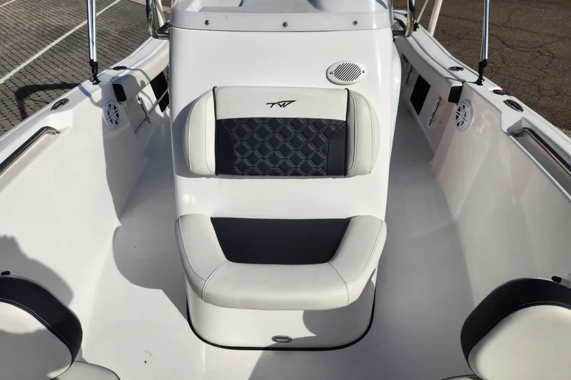 Slide: The Image of 2023 Tidewater 196 CC Adventure boat interior with cushioned seating and speakers. - 33