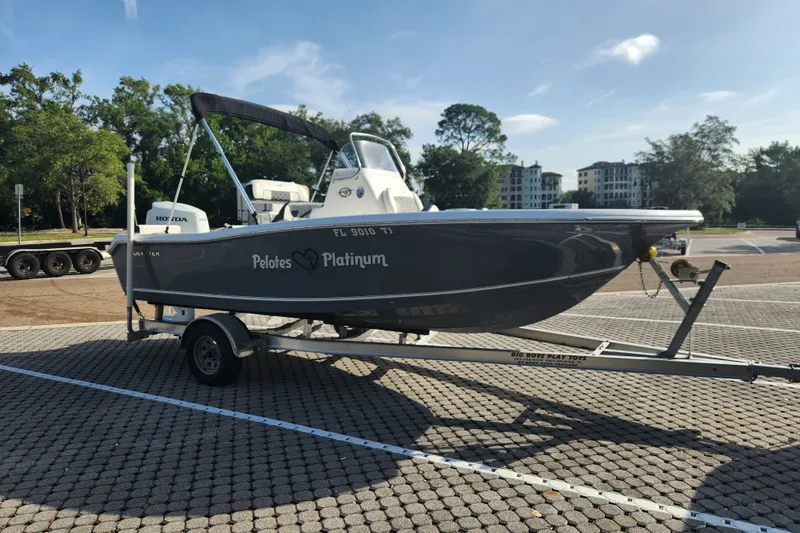 Slide: The Image of 2023 Tidewater 196 CC Adventure boat on trailer in sunny parking lot. - 6