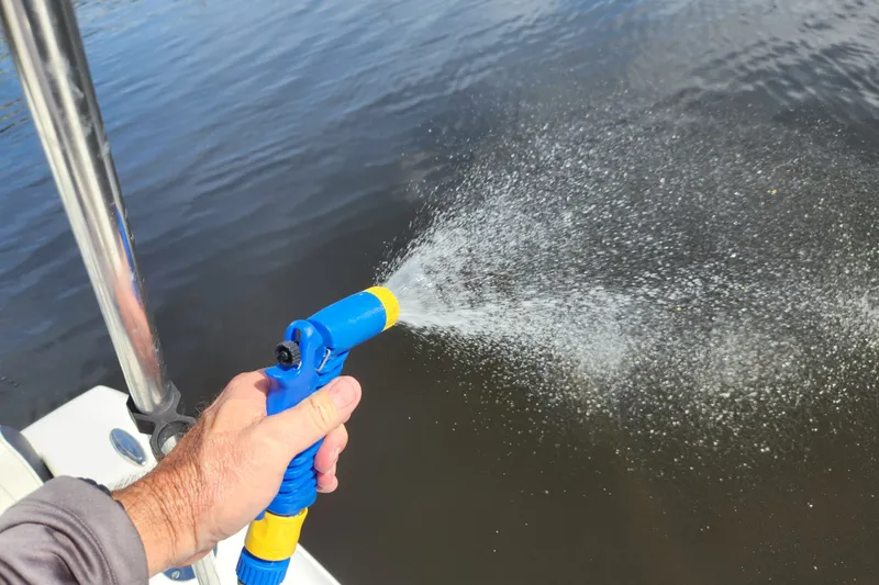 Slide: The Image of Hand spraying water from a boat, Tidewater 196 CC Adventure, 2023 model. - 52