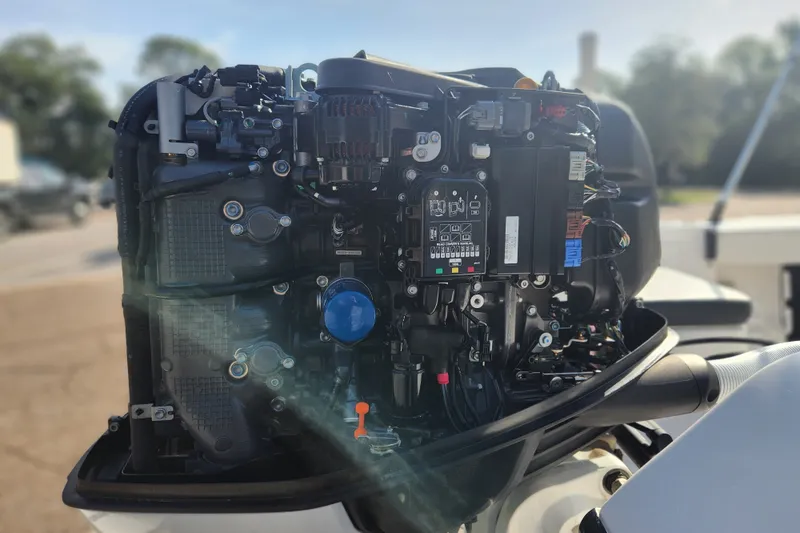 Slide: The Image of Close-up of a 2023 Tidewater 196 CC Adventure boat engine, showcasing intricate components. - 26