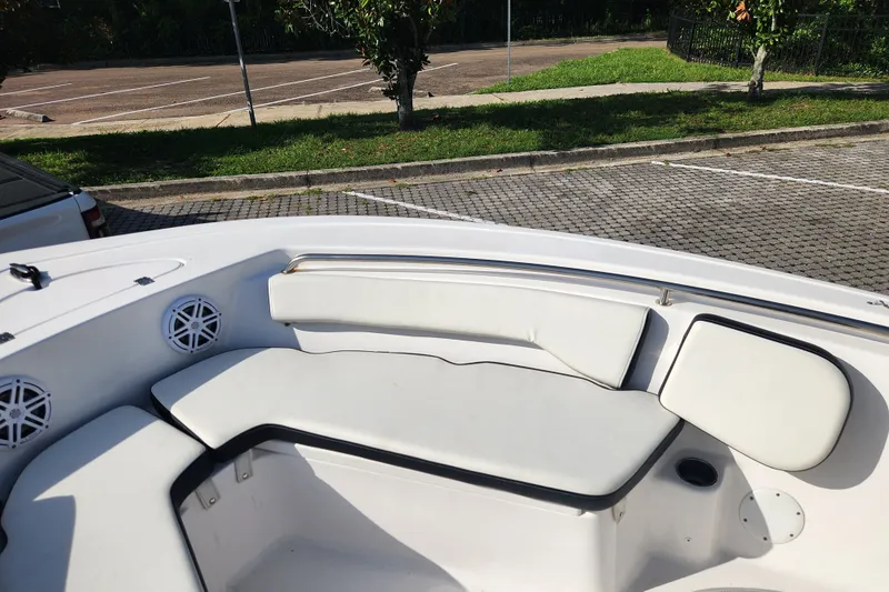 Slide: The Image of 2023 Tidewater 196 CC Adventure boat interior with white cushioned seating and speakers. - 30