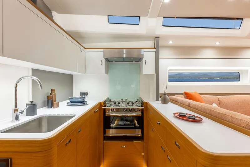Slide: The Image of Manufacturer Provided Image: Luxurious interior of 2026 Beneteau First 60 yacht, featuring modern kitchen and cozy seating area. - 5