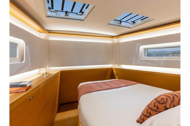 Slide: The Image of Manufacturer Provided Image: Luxurious cabin interior of 2026 Beneteau First 60 yacht, featuring modern design and natural lighting. - 6