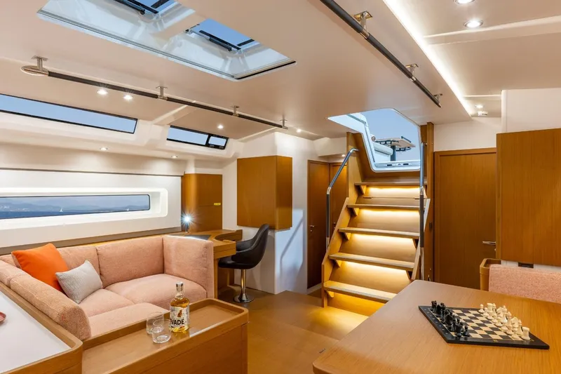 Slide: The Image of Manufacturer Provided Image: Luxurious interior of 2026 Beneteau First 60 yacht with modern furnishings and chessboard. - 2