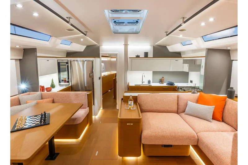 Slide: The Image of Manufacturer Provided Image: Luxurious interior of 2026 Beneteau First 60 yacht with modern kitchen and cozy seating area. - 4