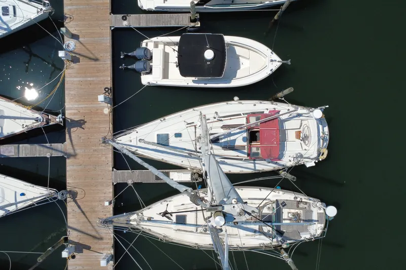 Slide: The Image of Aerial view of CAL 39 sailboats docked at a marina, showcasing their sleek design. - 10