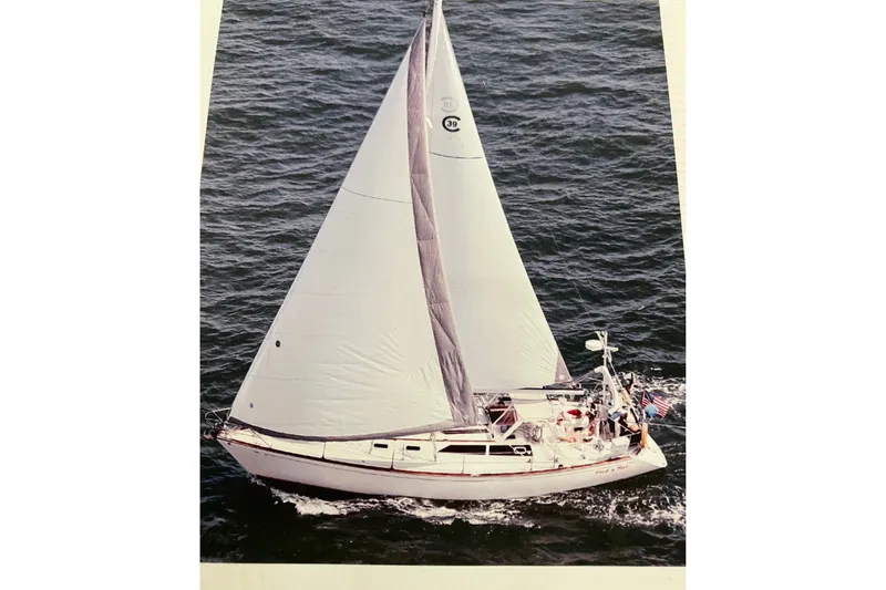 Slide: The Image of Sailing yacht CAL 39 from 1989 navigating open waters with full sails. - 44
