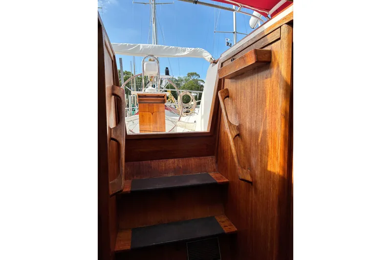 Slide: The Image of Wooden interior stairs leading to the deck of a 1989 CAL 39 sailboat. - 9