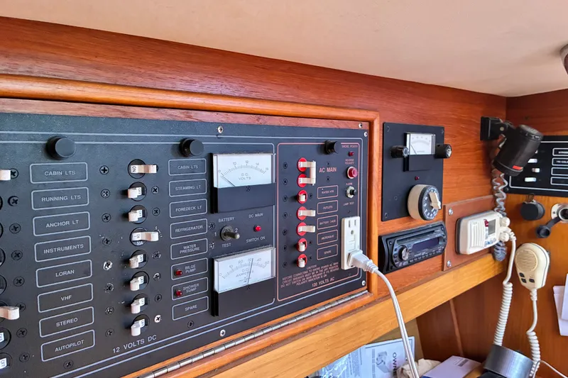 Slide: The Image of Control panel of a 1989 CAL 39 sailboat, featuring switches and gauges for electrical systems. - 15