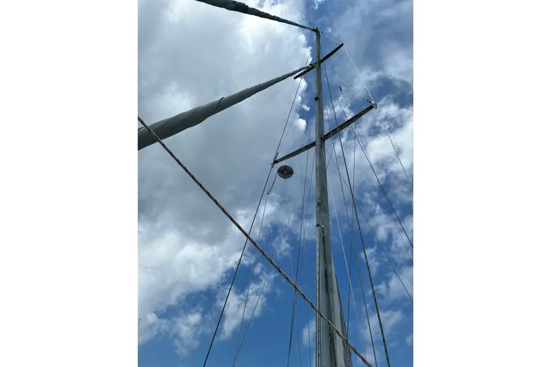 Slide: The Image of Sailboat mast against a cloudy sky, CAL 39 model, 1989. - 34