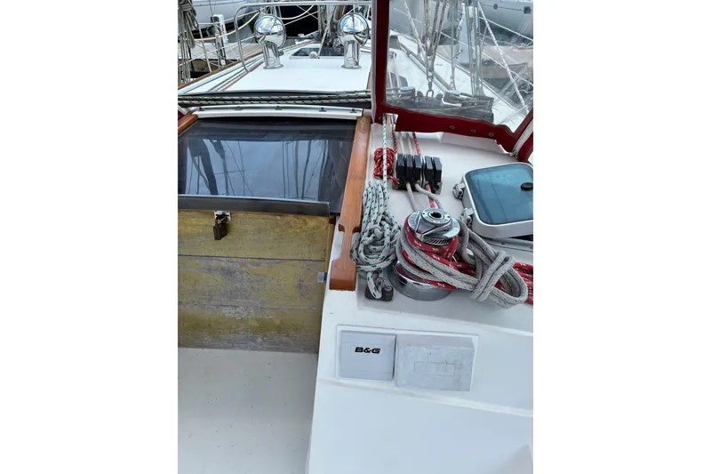 Slide: The Image of 1989 CAL 39 sailboat deck with ropes, winch, and navigation equipment. - 33