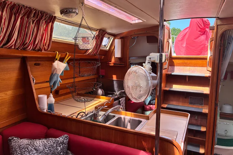 Slide: The Image of Interior of a 1989 CAL 39 sailboat with wooden finishes and cozy kitchen area. - 26
