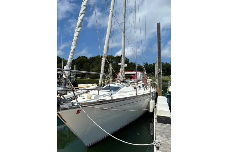 The Image of 1989 CAL 39 sailboat docked at marina under blue sky. - 12