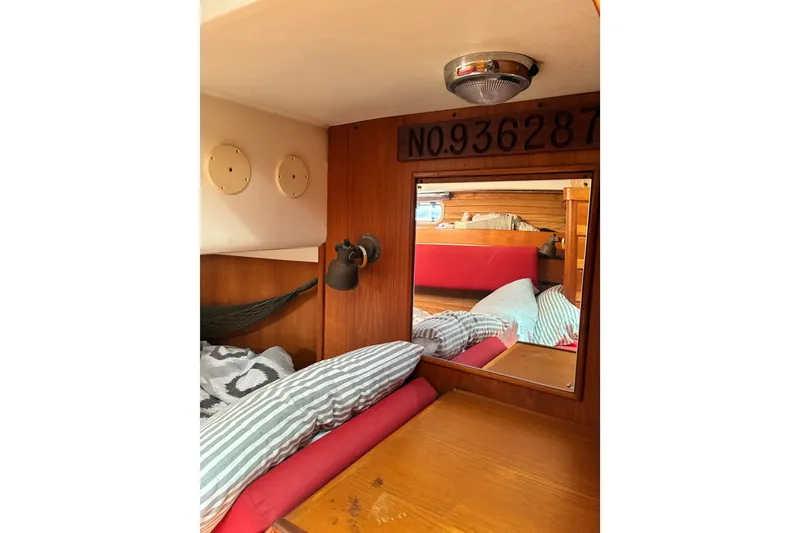 Slide: The Image of Cozy cabin interior of 1989 CAL 39 sailboat with wood paneling and bedding. - 18