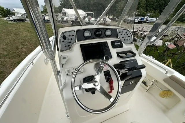 Slide: The Image of 2012 Scout 210 XSF boat dashboard with steering wheel and navigation controls. - 10