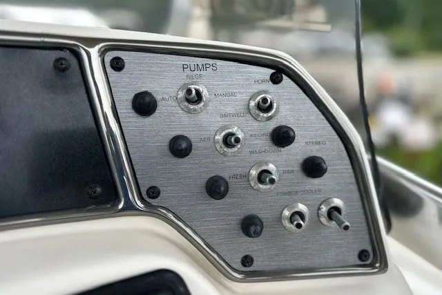 Slide: The Image of Control panel of a 2012 Scout 210 XSF boat with various switches and labels. - 14