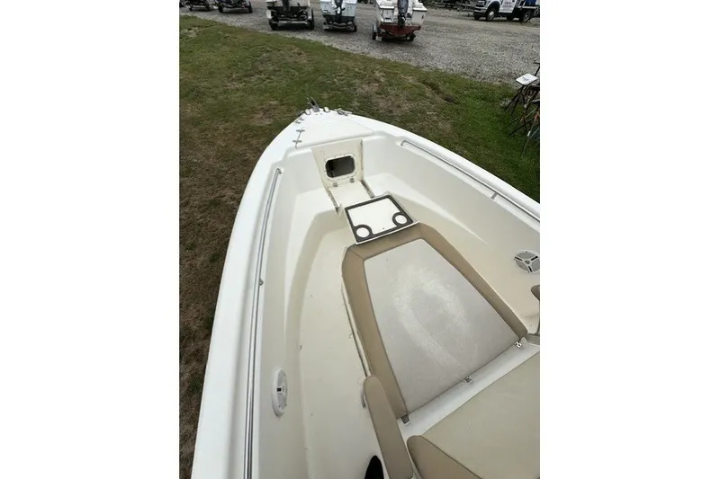 Slide: The Image of 2012 Scout 210 XSF boat interior with beige seating and storage compartments. - 9