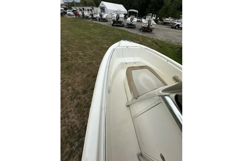 Slide: The Image of 2012 Scout 210 XSF boat on grassy area, surrounded by other boats. - 18