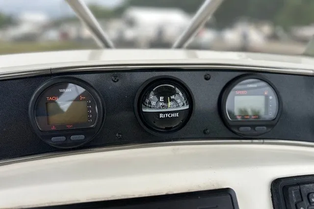 Slide: The Image of Dashboard of a 2012 Scout 210 XSF boat with Yamaha gauges and Ritchie compass. - 13